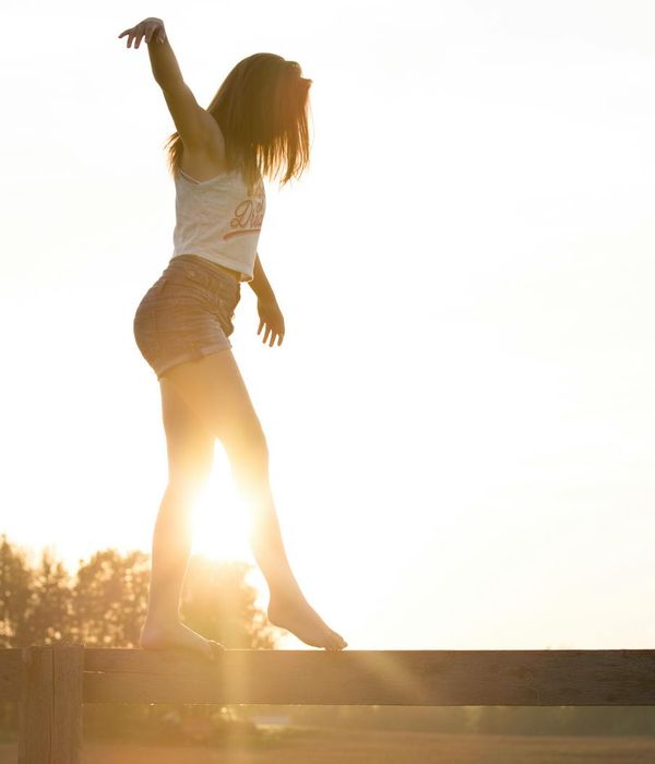 Silhouette of a person meditating with an energetic turquoise aura.